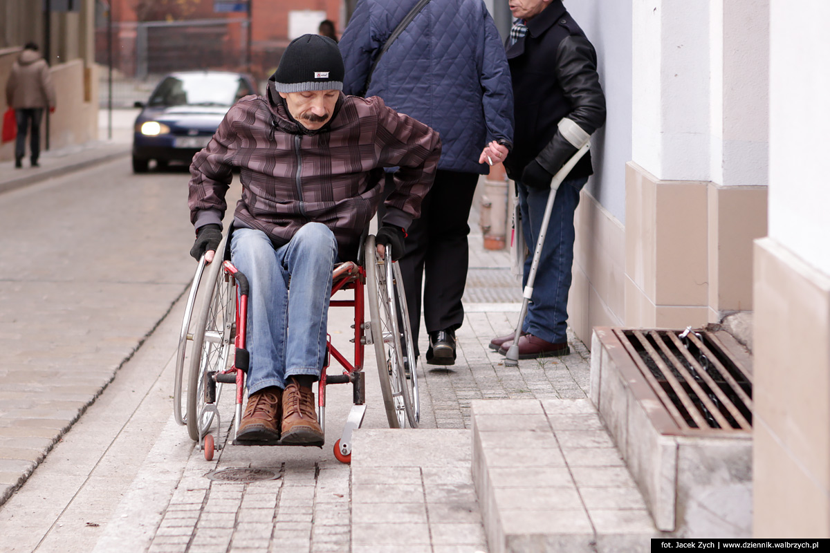 Niepełnosprawna osoba na wózku poruszająca "uciekająca" przed pojazdami w tzw "strefe zamieszkania" na ulicy Kościelnej w Wałbrzychu. Fot, Jacek Zych, Dziennik Wałbrzych